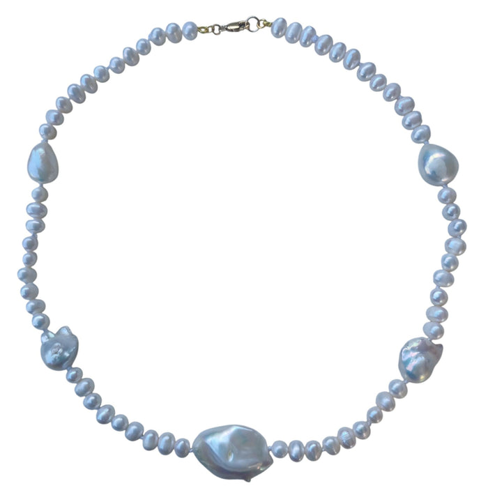 Pearl necklace with large baroque pearls on a white background