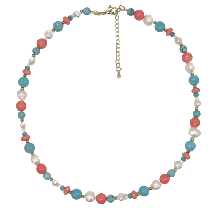 A necklace with a mix of round turquoise, freshwater pearl, and coral beads, with an 18k gold plated brass clasp.