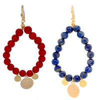 A pair of elegant earrings featuring round red sea bamboo coral and round lapis lazuli stones, with gold-plated brass hooks.